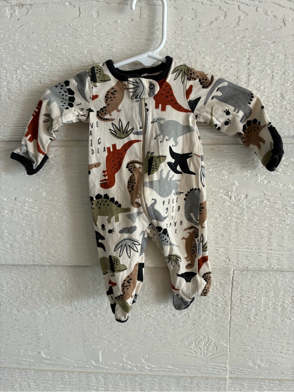 Gerber Cream Dinosaur Print Footed One-Piece with Black Trim